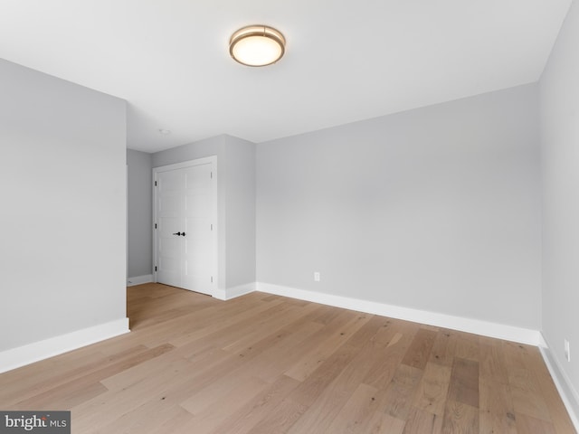 spare room with light wood-style flooring and baseboards