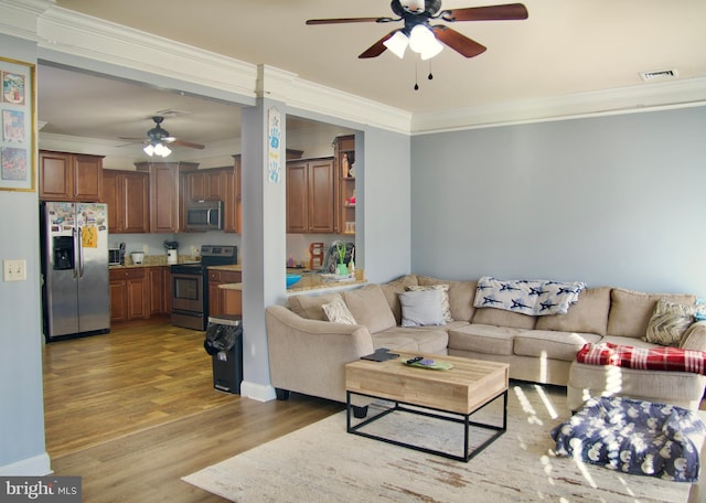 215 Whitley Dr, Chambersburg, PA 17202 - living room featuring ornamental molding, visible vents, light wood-type flooring, and a ceiling fan