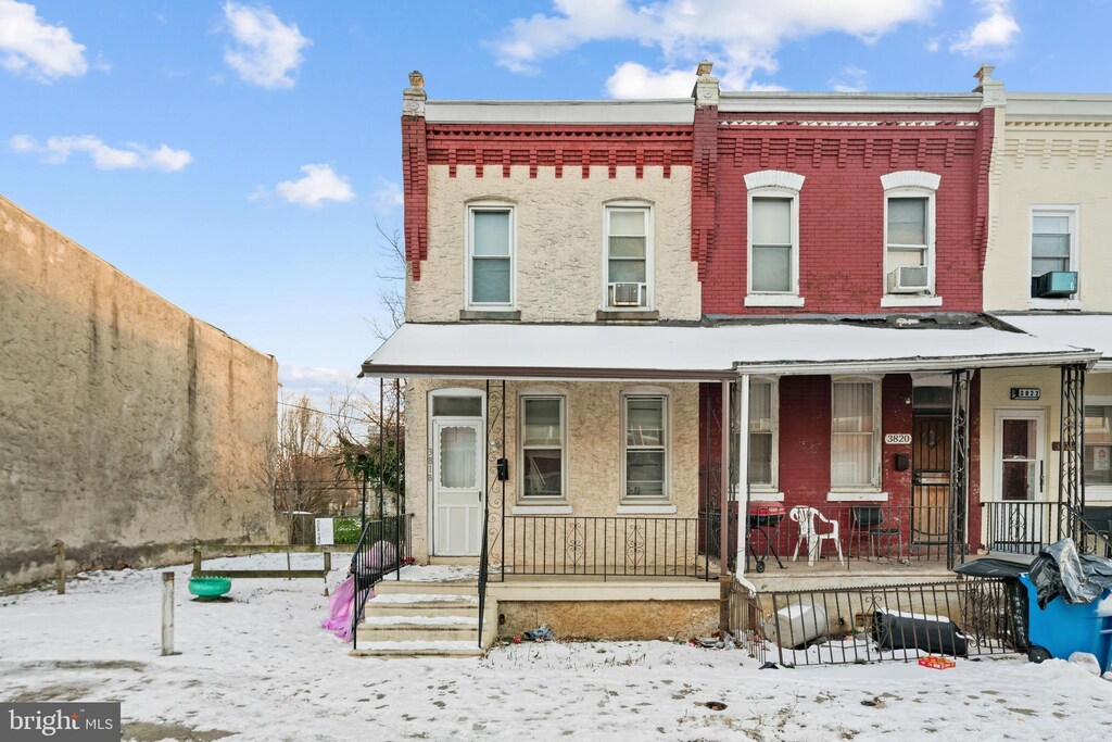 3818 Reno St, Philadelphia, PA 19104 - view of property with brick siding, a porch, cooling unit, and fence