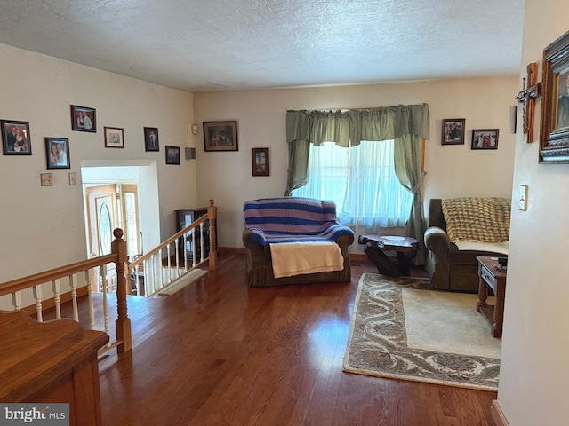living area featuring a textured ceiling and wood finished floors