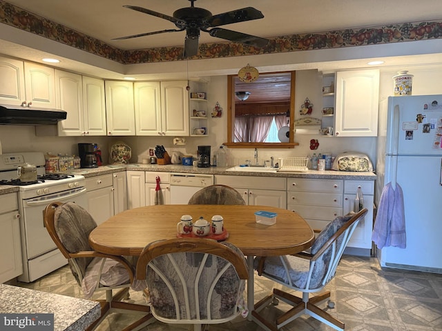 kitchen featuring a ceiling fan, open shelves, a sink, under cabinet range hood, and white appliances