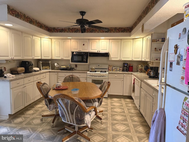 kitchen featuring white cabinets, white appliances, light countertops, a ceiling fan, and under cabinet range hood