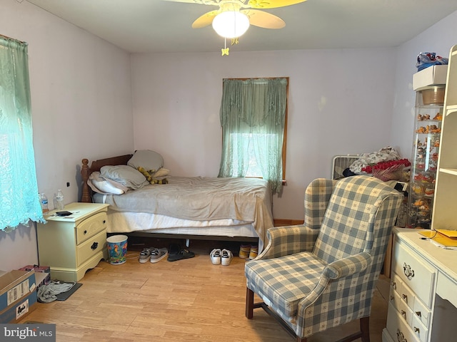 bedroom with light wood-style floors and a ceiling fan