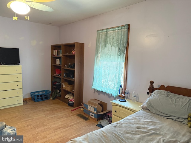 bedroom with ceiling fan, visible vents, and light wood-type flooring