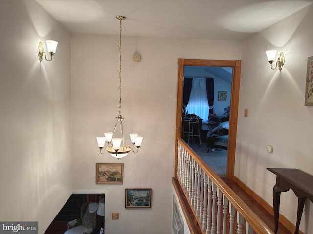 corridor with a notable chandelier
