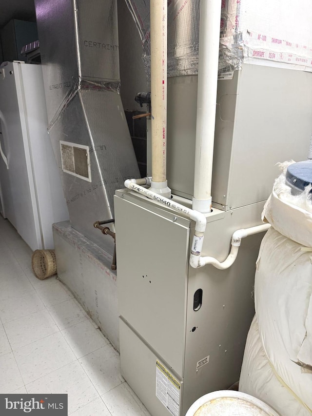 utility room featuring heating unit