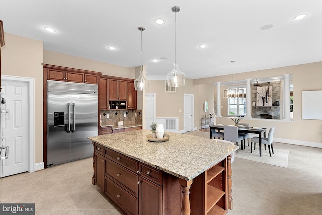 kitchen with backsplash, open shelves, hanging light fixtures, and stainless steel built in refrigerator