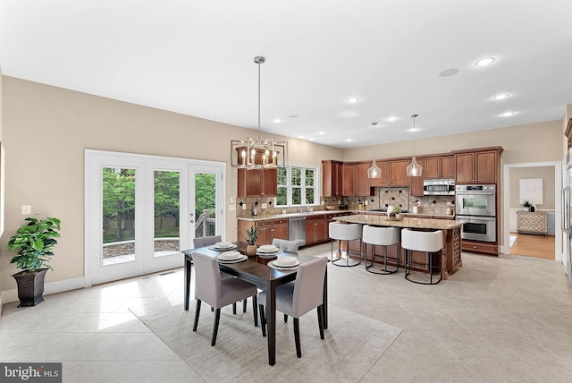dining space with light tile patterned floors, baseboards, recessed lighting, and a chandelier
