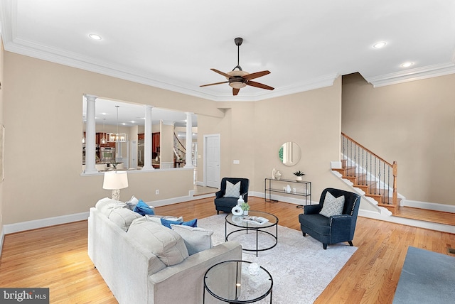 living room with ornamental molding, decorative columns, a ceiling fan, and wood finished floors