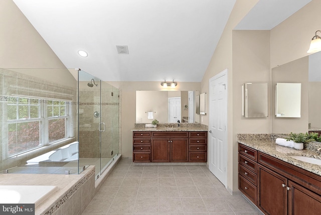 full bathroom with tile patterned floors, vaulted ceiling, a stall shower, and visible vents