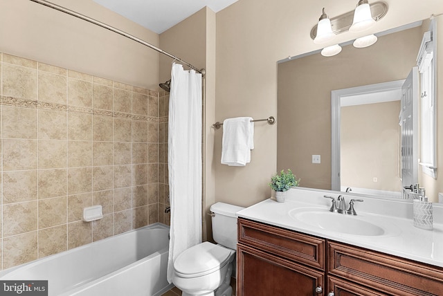 full bathroom featuring vanity, shower / tub combo with curtain, and toilet