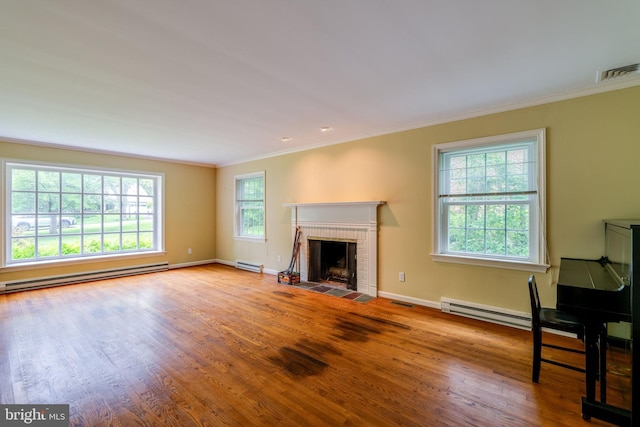 1428 Center Rd, Lancaster, PA 17603 - unfurnished living room with a baseboard heating unit, crown molding, wood finished floors, and a brick fireplace
