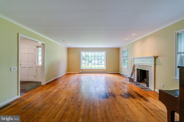 1428 Center Rd, Lancaster, PA 17603 - unfurnished living room with a baseboard heating unit, wood finished floors, baseboards, crown molding, and a fireplace