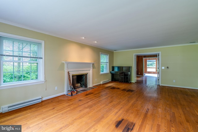 1428 Center Rd, Lancaster, PA 17603 - unfurnished living room featuring a baseboard radiator, wood finished floors, plenty of natural light, and ornamental molding