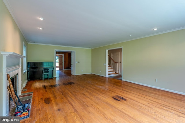 1428 Center Rd, Lancaster, PA 17603 - unfurnished living room with crown molding, a fireplace with flush hearth, stairway, wood finished floors, and baseboards