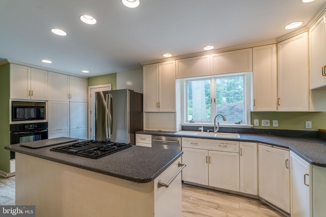 1428 Center Rd, Lancaster, PA 17603 - kitchen featuring black appliances, a sink, a kitchen island, recessed lighting, and white cabinets