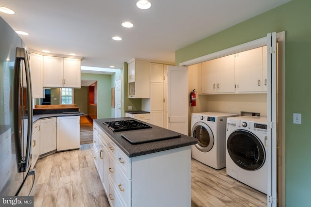 1428 Center Rd, Lancaster, PA 17603 - washroom with washing machine and clothes dryer, light wood finished floors, cabinet space, and recessed lighting