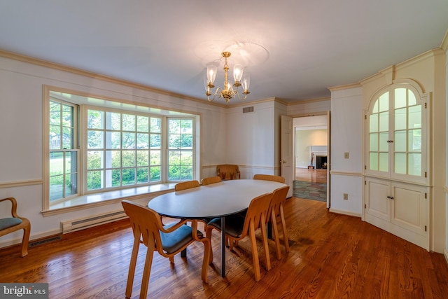 1428 Center Rd, Lancaster, PA 17603 - dining area with wood finished floors, a chandelier, plenty of natural light, a baseboard heating unit, and ornamental molding