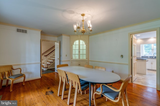 1428 Center Rd, Lancaster, PA 17603 - dining room featuring stairs, a chandelier, ornamental molding, and light wood finished floors