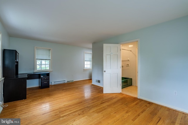 1428 Center Rd, Lancaster, PA 17603 - unfurnished living room with light wood finished floors, baseboards, and a baseboard radiator