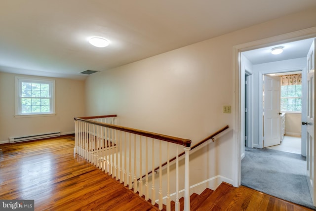 1428 Center Rd, Lancaster, PA 17603 - stairs with a baseboard heating unit, wood finished floors, and baseboards