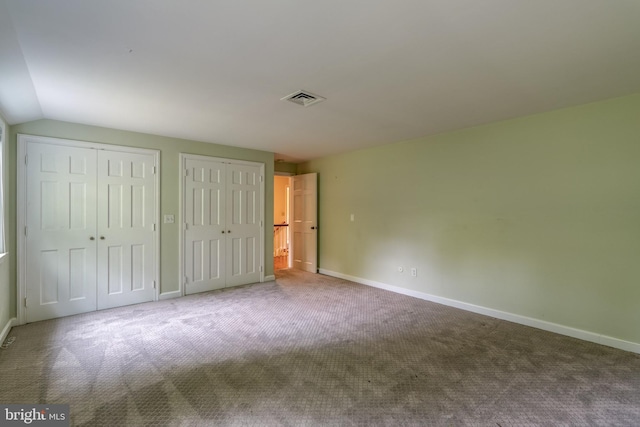 1428 Center Rd, Lancaster, PA 17603 - unfurnished bedroom featuring multiple closets, carpet floors, baseboards, and lofted ceiling