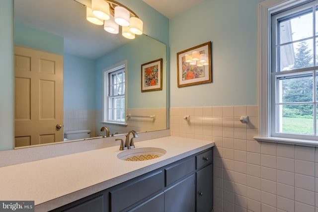 1428 Center Rd, Lancaster, PA 17603 - half bathroom with toilet, vanity, wainscoting, tile walls, and a chandelier