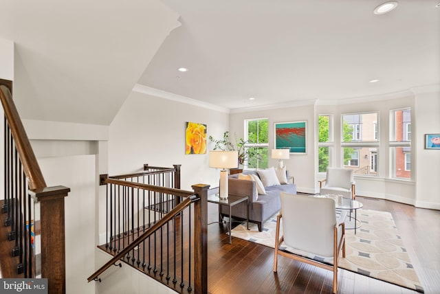 living area featuring hardwood / wood-style flooring, baseboards, recessed lighting, and ornamental molding