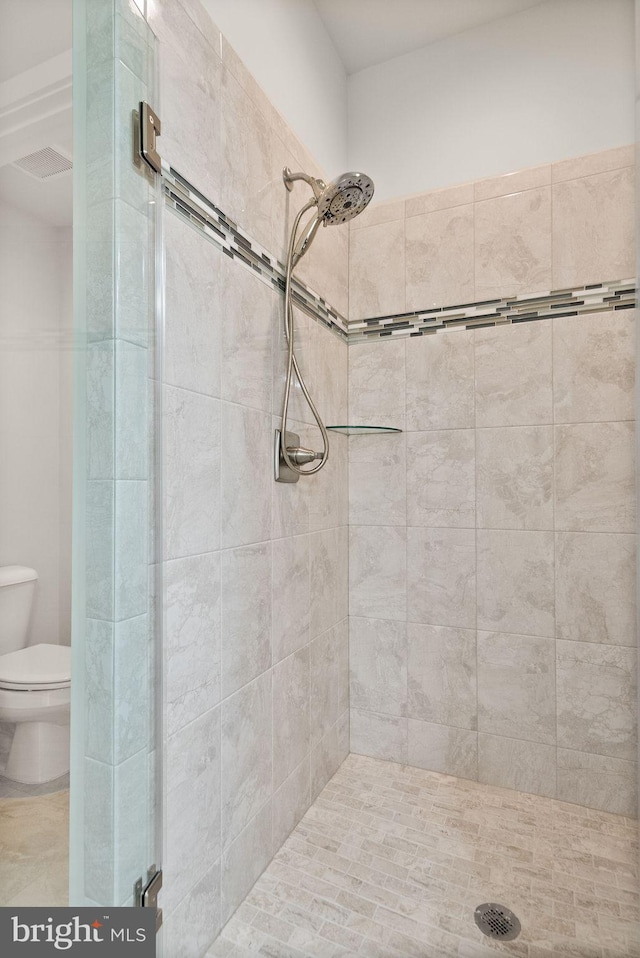full bath featuring toilet and a stall shower