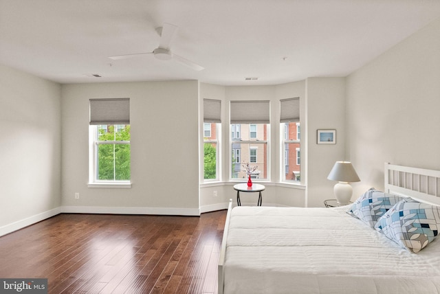 bedroom featuring baseboards, a ceiling fan, and hardwood / wood-style flooring