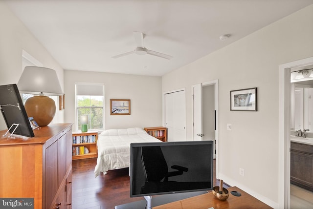 bedroom with dark wood finished floors and a sink