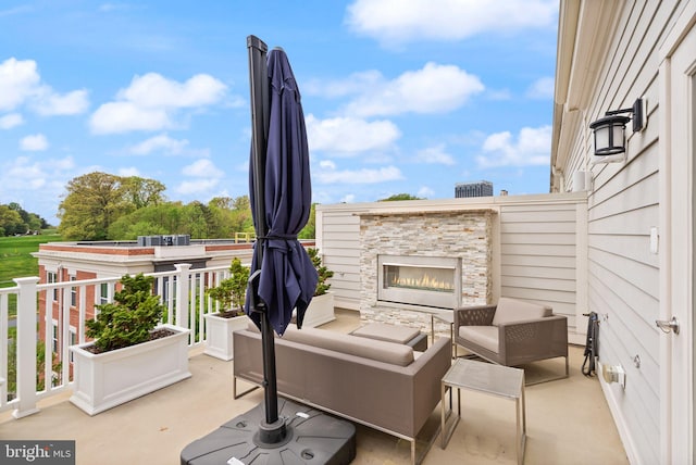 view of patio / terrace with an outdoor living space with a fireplace
