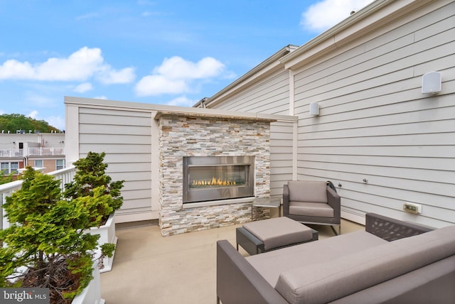 view of patio / terrace with an outdoor living space with a fireplace