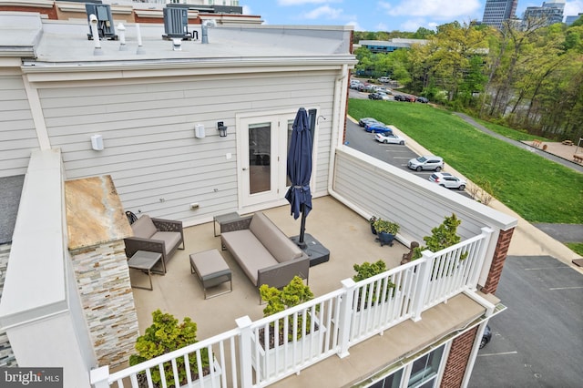 exterior space featuring an outdoor hangout area, a balcony, and central air condition unit