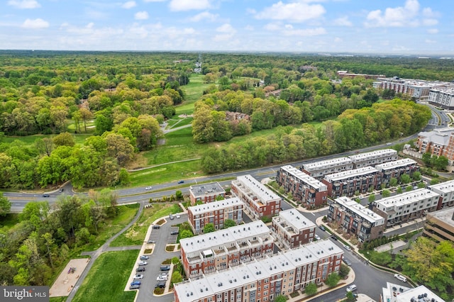drone / aerial view featuring a wooded view