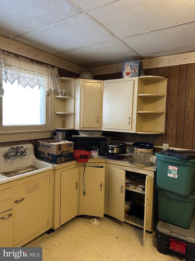 6573 Raystown Rd, Hopewell, PA 16650 - kitchen with wooden walls, light countertops, open shelves, light floors, and a sink