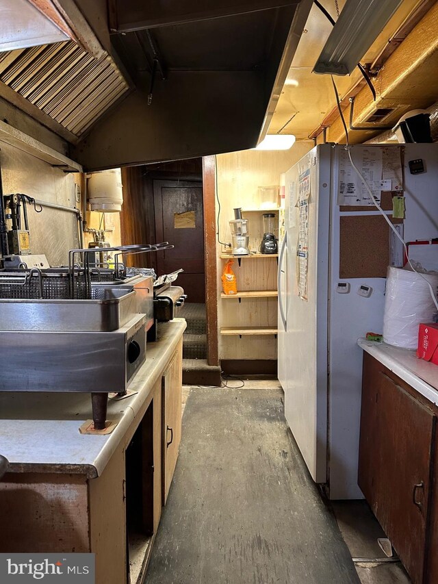 6573 Raystown Rd, Hopewell, PA 16650 - interior space with freestanding refrigerator, light countertops, lofted ceiling, and unfinished concrete floors
