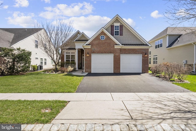 view of front of house with a front yard, central AC, a garage, brick siding, and driveway