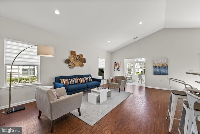 living area with hardwood / wood-style floors, baseboards, and plenty of natural light