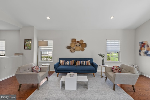 living room featuring a wealth of natural light, recessed lighting, baseboards, and wood finished floors