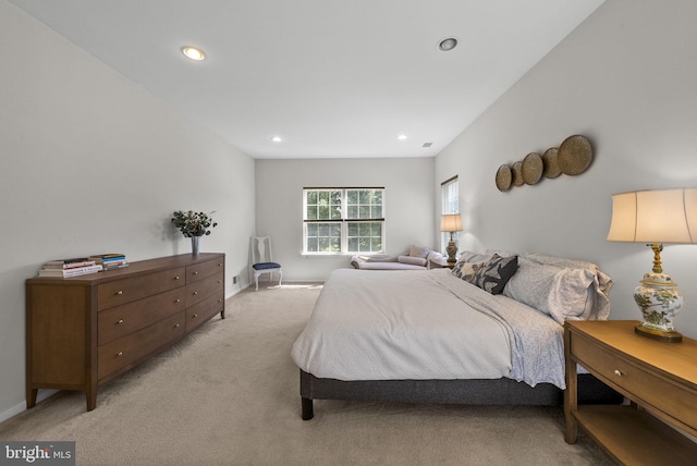 bedroom with baseboards, recessed lighting, and light colored carpet