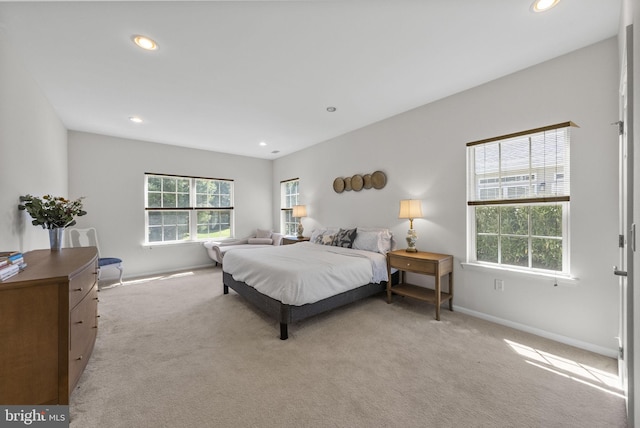 bedroom with recessed lighting, light colored carpet, and baseboards