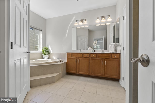 bathroom with a bath, double vanity, a sink, and tile patterned flooring