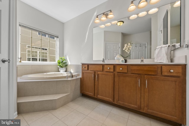 bathroom featuring a sink, a bath, double vanity, and tile patterned flooring