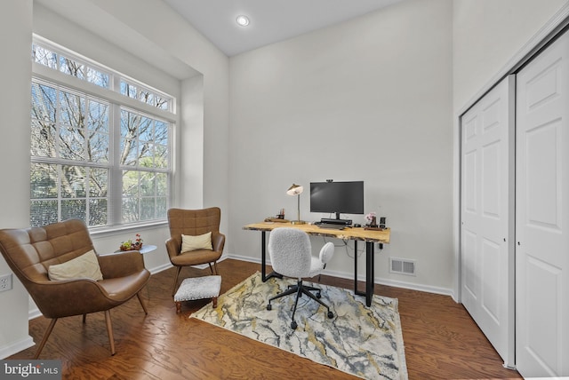 home office featuring visible vents, baseboards, and wood finished floors