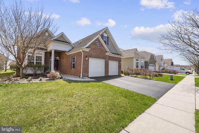 view of front of home featuring aphalt driveway, brick siding, and a front yard