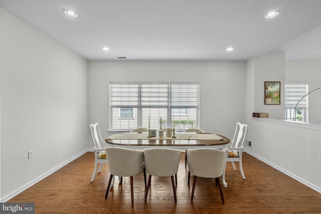 dining space with recessed lighting, baseboards, and wood finished floors