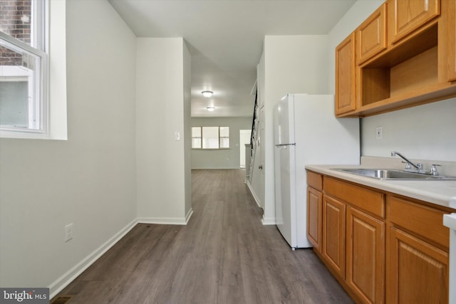 517 N 64th St, Philadelphia, PA 19151 - kitchen featuring freestanding refrigerator, dark wood-style flooring, light countertops, a sink, and baseboards