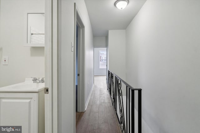 517 N 64th St, Philadelphia, PA 19151 - corridor with baseboards, wood-type flooring, an upstairs landing, and a sink