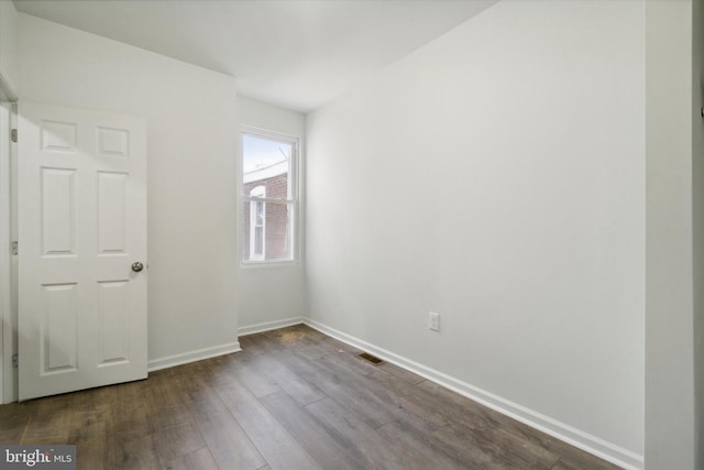 517 N 64th St, Philadelphia, PA 19151 - unfurnished bedroom with dark wood-type flooring, baseboards, and visible vents